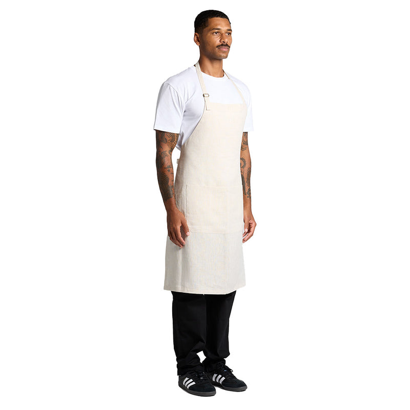 Load image into Gallery viewer, AS Colour 1086 Linen Apron features an adjustable shoulder strap with a YKK metal adjuster, front patch pocket, and self-fabric waist ties, ideal for active workplace environments.
