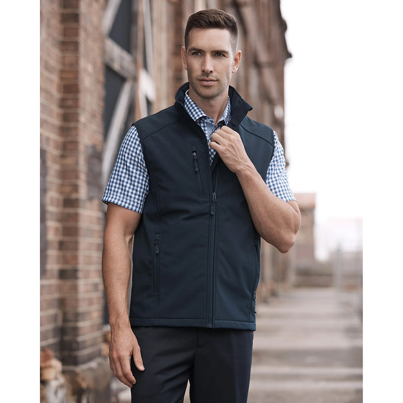 Load image into Gallery viewer, Olympus Mens Soft Shell Vest worn by a man, featuring a performance softshell design, zip pockets, and shaped back tail, ideal for safety and workwear from Active Safety.