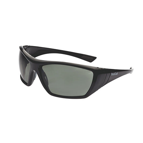 Bolle Hustler Polarised Safety Glasses: Grey/Green, featuring sleek black frames with gray lenses, designed for outdoor protection, blocking 99.99% UVA/UVB rays, suitable for extended high-glare environments.