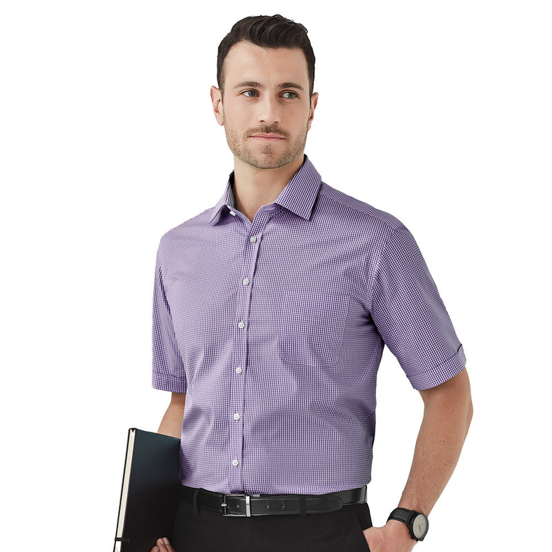 Load image into Gallery viewer, Biz Mens Newport Short Sleeve Shirt showcased by a man in a purple gingham pattern, emphasizing its premium cotton-rich fabric with stretch for comfort, suitable for workplace or casual wear.