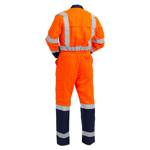 A person wearing the Bison LW Cotton TTMC-W Overall, Orange/Navy (CTPCOLW), featuring reflective stripes, zipped chest pockets, and Velcro cuffs. Ideal for high-visibility workwear needs in safety-focused environments.