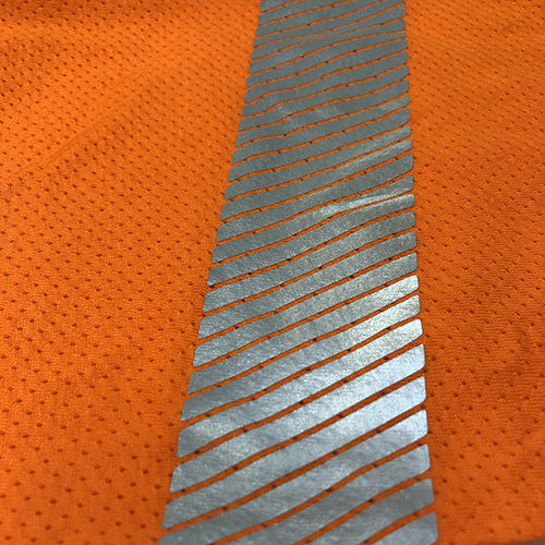 ST Cotton Mesh TTMC-W17 L/S Polo Shirt features a silver reflective stripe on orange fabric, designed for optimal breathability and movement, ideal for hot conditions. Includes a large front pocket with button closure.