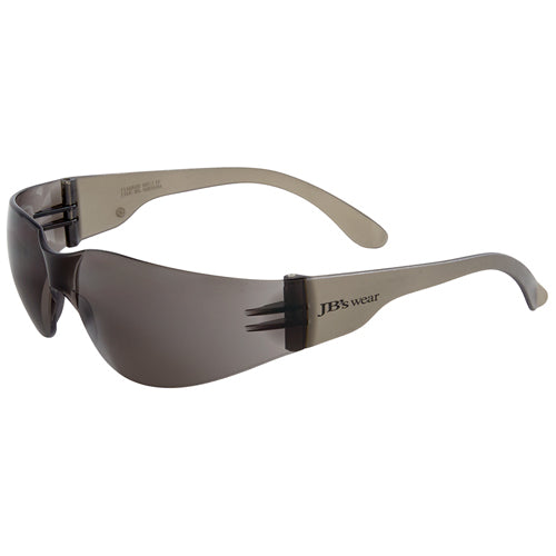JB's Saver Spec: Smoke sunglasses with a sleek, rimless polycarbonate frame and wrap-around design for optimal eye protection. The one-piece lens offers unobstructed vision, ideal for safety and comfort.