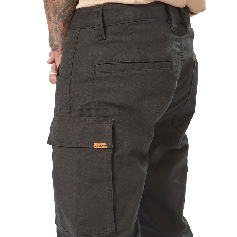 Load image into Gallery viewer, Volcom Workwear Caliper Pant showcased with tattooed arm, highlighting the durable fabric and modern fit. Features include rear welt and patch pockets, dual entry cargo pocket, and reinforced stitching for enhanced durability.