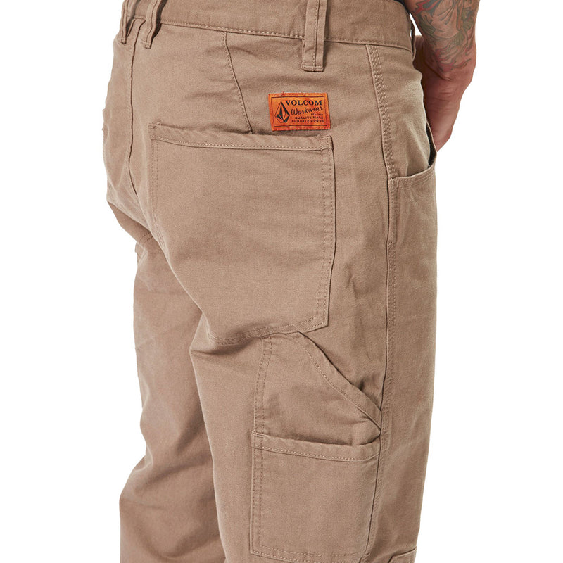 Load image into Gallery viewer, Close-up of Volcom Workwear Caliper Pant, highlighting back pocket and durable fabric, emphasizing its utility and reinforced details suitable for active, safety-focused work environments.