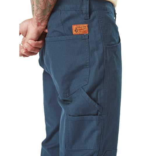 Volcom Workwear Caliper Pant displayed with visible rear pocket details, showcasing durable construction and modern fit, ideal for active work environments. Reinforced elements suitable for safety-focused settings.