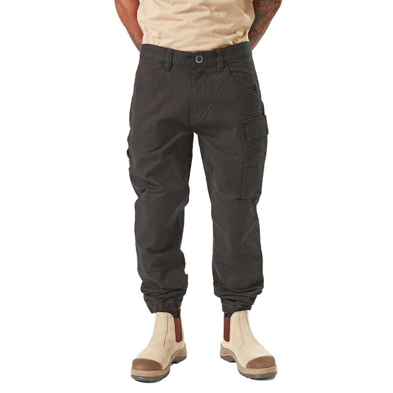 Load image into Gallery viewer, Volcom Workwear Caliper Cuffed Pant showcased on a man, highlighting its tapered leg, utility and cargo pockets, and reinforced knees, epitomizing style and durability for active work environments.