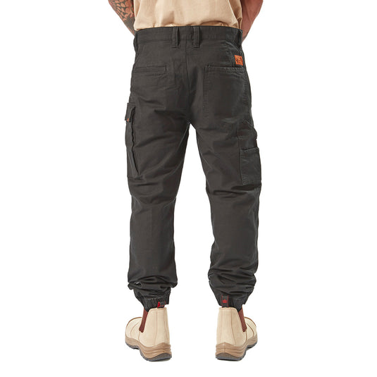 Volcom Workwear Caliper Cuffed Pant showcased on a person, highlighting its modern Solver fit, tapered leg with elastic cuff, and utility pockets, embodying durability and style for active work environments.