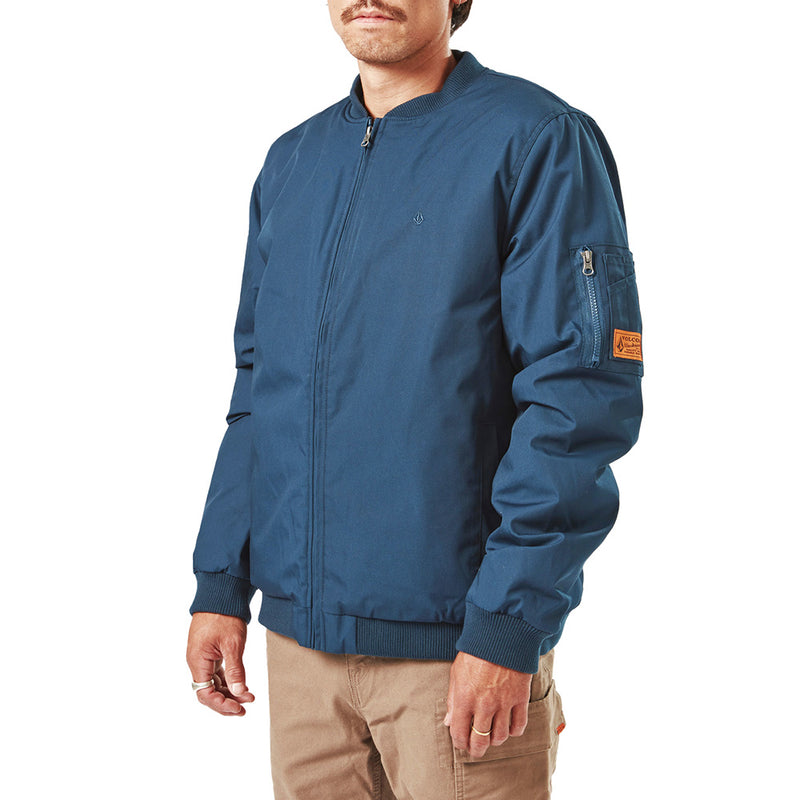 Load image into Gallery viewer, Volcom Workwear Water Resistant Bomber Jacket showcases durable design with a zipper sleeve pocket, perfect for active safety and work environments. The image highlights its functional style and polyester insulation.