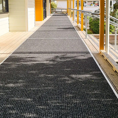 AKO Non Slip Safety Mat: 1800 x 10m Roll featured on a walkway, showcasing its textured, slip-resistant surface ideal for enhancing safety in various indoor and outdoor environments.