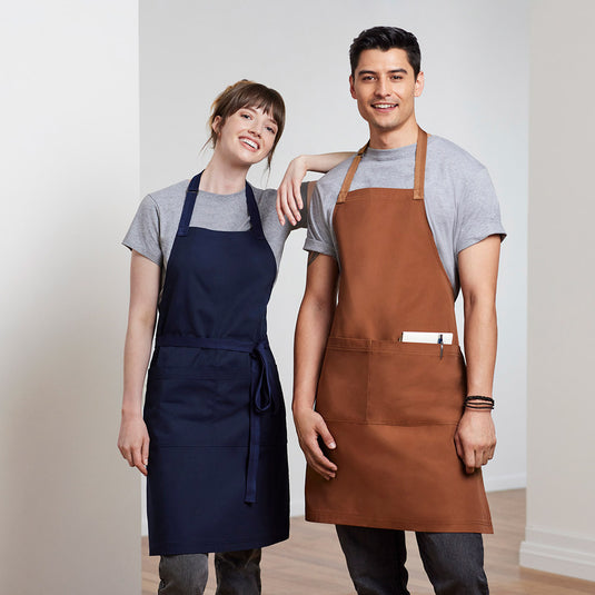 Biz Barley Apron in durable no-fade canvas, featuring an adjustable neck strap, large split front pocket, and reinforced herringbone straps, ideal for uniformed work environments and commercial laundering.