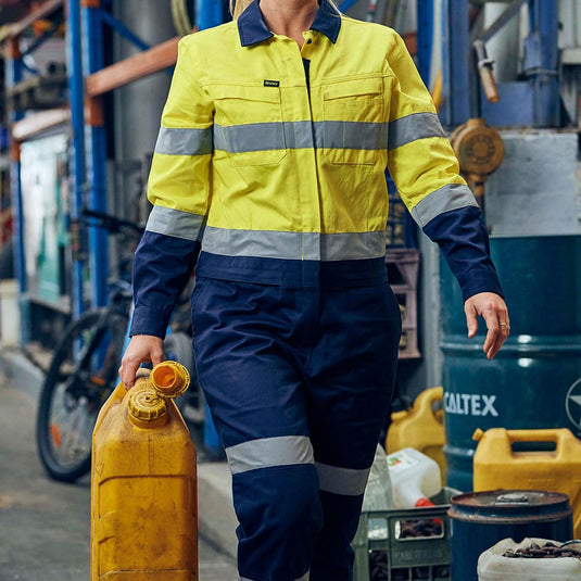 Bisley Women's Hi Vis Taped Cotton Drill Coverall featuring reflective hoop and biomotion taping, multi-function pockets, and a drop back waist zip for convenience, designed for durability and antimicrobial protection.