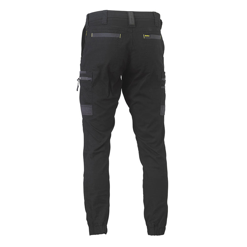 Load image into Gallery viewer, Bisley Flex & Move Stretch Cargo Cuffed Pants showcase a back view with belt loops, elastic cuffs, and zip cargo pockets, designed for durability and comfort with Cordura® reinforcements and a curved waistband.
