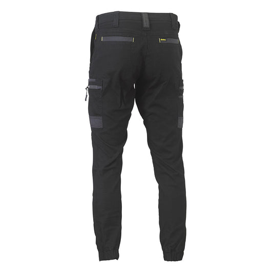 Bisley Flex & Move Stretch Cargo Cuffed Pants showcase a back view with belt loops, elastic cuffs, and zip cargo pockets, designed for durability and comfort with Cordura® reinforcements and a curved waistband.