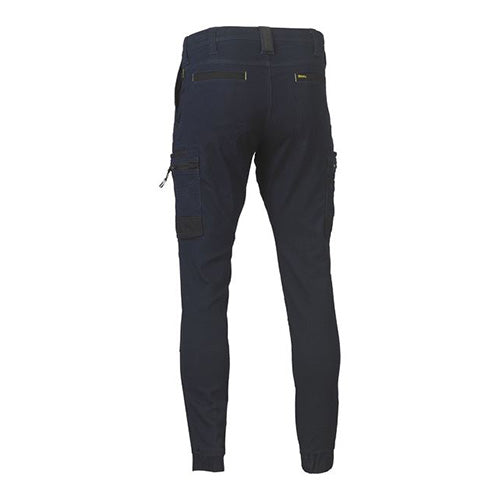 Bisley Stretch Denim Cargo Cuffed Pants featuring multifunctional pockets, oversized cargo pockets, and tool loops. Designed with Cordura® reinforcements and double-layer knees for durability, ideal for workplace safety and comfort.