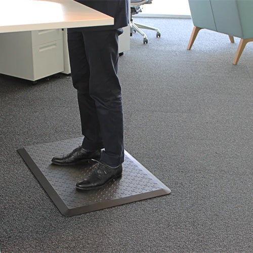 Comfort Pro Ergonomic Anti-Fatigue Mat: 910 x 610mm, featuring a person standing on the cushioned surface, ideal for reducing joint strain at stand-up desks or workstations.