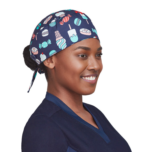 Biz Unisex Printed Scrub Cap made of soft, breathable 100% cotton, features an elasticated back for bun coverage and side buttons for mask attachment, designed for comfort and practical use in active safety environments.