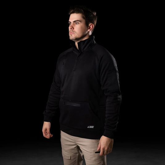 BAD Waterproof Rain-Defend Hi-Vis Fleece 1/4 Zip Jumper worn by a man, showcasing its front pouch pocket, chest pocket, and sleeve utility pockets, emphasizing its functional design for active safety.