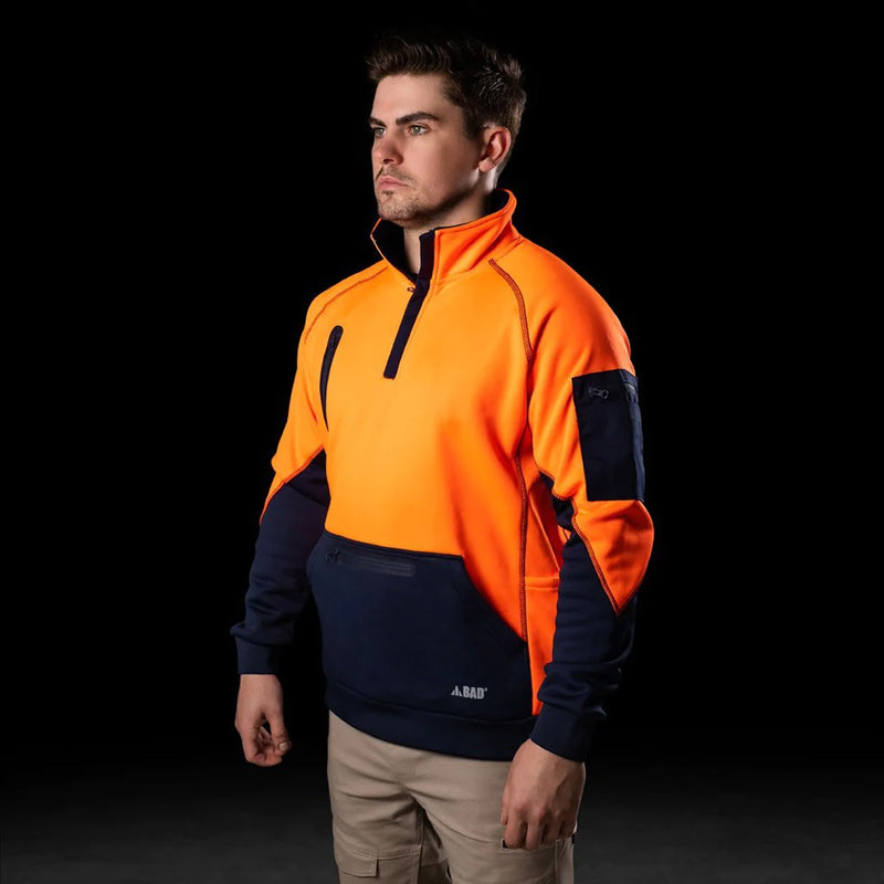 Load image into Gallery viewer, BAD Waterproof Rain-Defend Hi-Vis Fleece 1/4 Zip Jumper featuring a front pouch with a waterproof zip pocket, multiple utility pockets, and elasticated wrists and waist, designed for warmth and functionality in safety work environments.