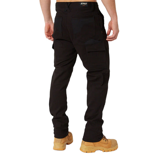 The image displays a back view of a person wearing Jet Pilot Fueled Utility Pant, highlighting slim-fit cargo design with flap pockets, paired with work boots, emphasizing comfort and performance for active job site roles.