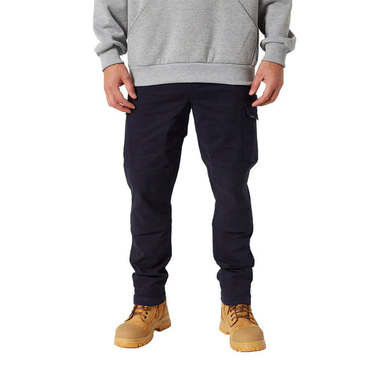 Jetpilot Fueled Utility Pant with flap pocket, visible articulated knees, and tan work-style boots, showcases performance stretch and durability, ideal for active workwear.