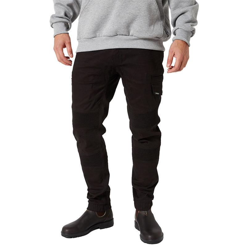 Load image into Gallery viewer, Jetpilot Fueled Corrugated Stretch Pant features articulated knees, ribbed detailing, and a side cargo pocket, paired with Chelsea-style boots, showcasing a durable and stylish workwear look.