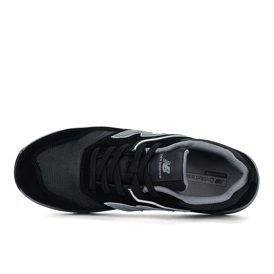 New Balance Elite Lite Safety Shoe, Black/Grey, top-down view showing mesh and suede upper, lace-up design, padded collar and tongue, with New Balance logo on tongue and insole.