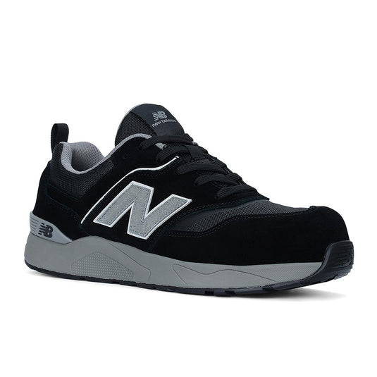 New Balance Elite Lite Safety Shoe, Black/Grey, featuring mesh-and-suede upper, New Balance “N” logo, padded collar, chunky midsole, and composite safety toe for stylish, protective workplace wear.