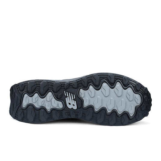 Close-up of the New Balance Fresh Foam Cremorne 2E Safety Shoe outsole, showcasing multi-directional lug pattern and molded NB logo for traction, embodying innovative safety and comfort for industrial work environments.