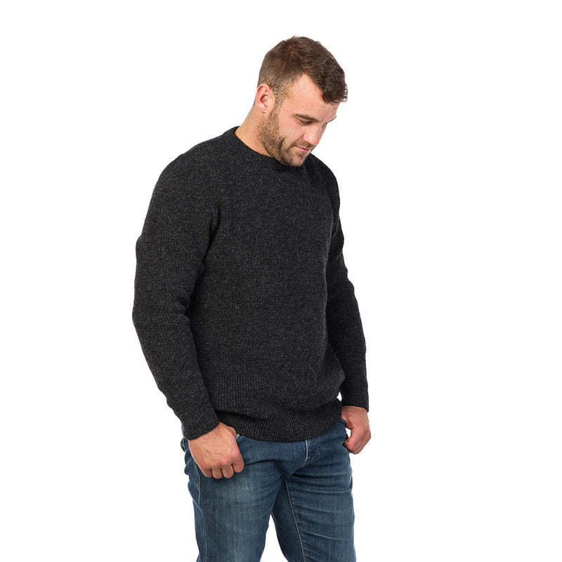Load image into Gallery viewer, MKM Backyard Wool Jersey showcased on a man standing, wearing the crewneck pullover with a loose fit, ideal for layering. Crafted from durable New Zealand wool, perfect for outdoor workwear.