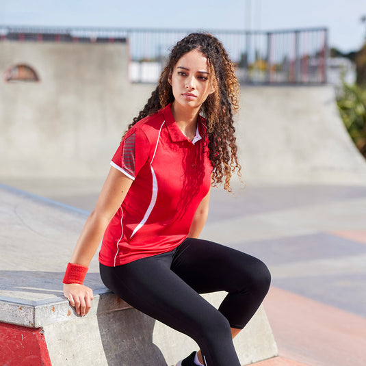 Biz Ladies Razor Polo Shirt featuring grid mesh underarm panels for breathability, dynamic sleeve print, and contrast piping. Designed with BIZ COOL™ interlock knit fabric for enhanced comfort and performance.