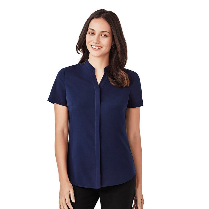 Load image into Gallery viewer, Biz Juliette Women’s Plain Blouse: A woman smiles wearing this easy-care, durable blouse with concealed placket and hidden bust button, perfect for workwear. Ideal for professional settings, offering comfort and style.
