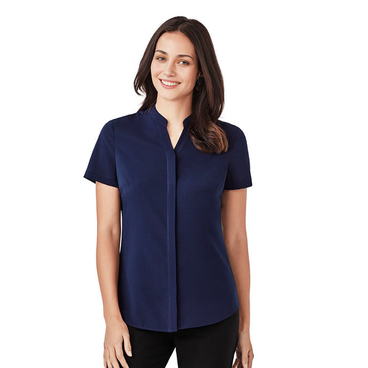 Biz Juliette Women’s Plain Blouse: A woman smiles wearing this easy-care, durable blouse with concealed placket and hidden bust button, perfect for workwear. Ideal for professional settings, offering comfort and style.