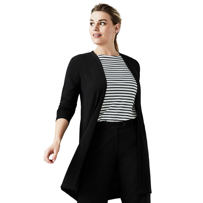 Load image into Gallery viewer, A woman wearing the Biz Ladies Chelsea Long Line Cardigan, a black wool blend knit, layered over a striped shirt, ideal for transitioning from winter warmth to summer office air-conditioning.