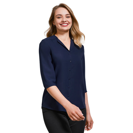 Biz Womens Lily Longline Blouse showcases a fluid, voluminous silhouette with a soft petal-shaped lapel and extended back. Ideal for workplace ease, featuring a hi-lo design and short sleeves.