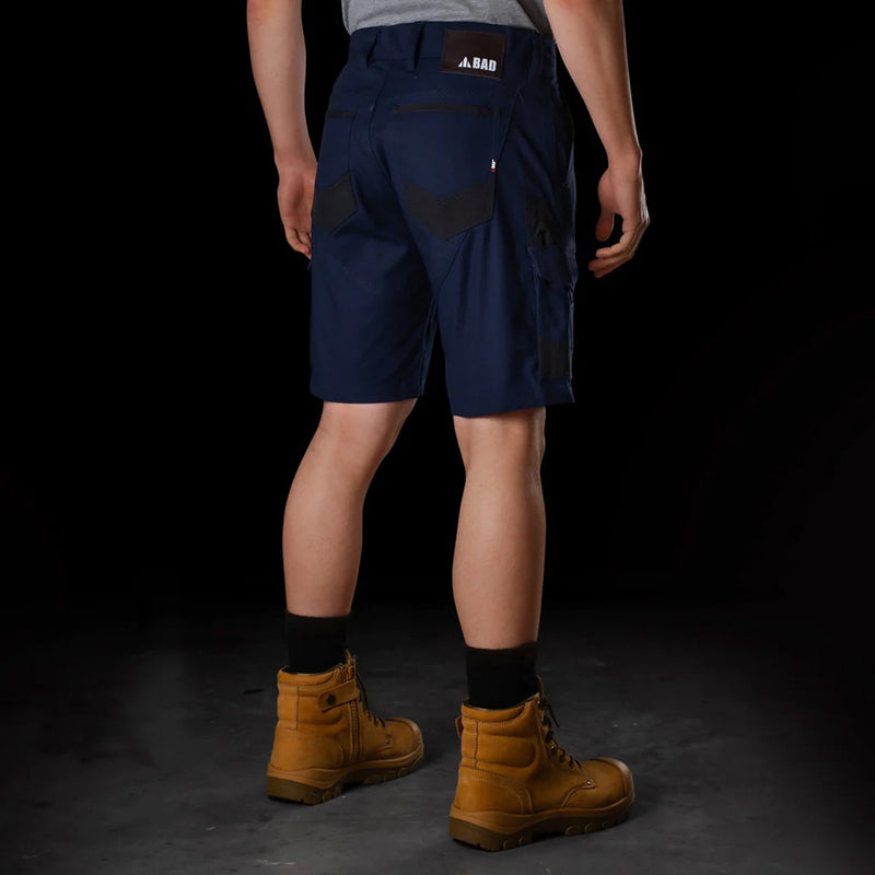 Load image into Gallery viewer, BAD Attitude Slim Fit Work Shorts showcased with brown boots, highlighting reinforced pockets and a hammer loop, ideal for workplace efficiency and comfort, reflecting Active Safety's commitment to durable workwear.
