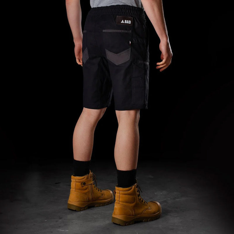 Load image into Gallery viewer, BAD Saviour Elastic Waist Work Shorts worn with brown boots, highlighting the shorts' adjustable drawstring and reinforced pockets, ideal for active safety and work environments.