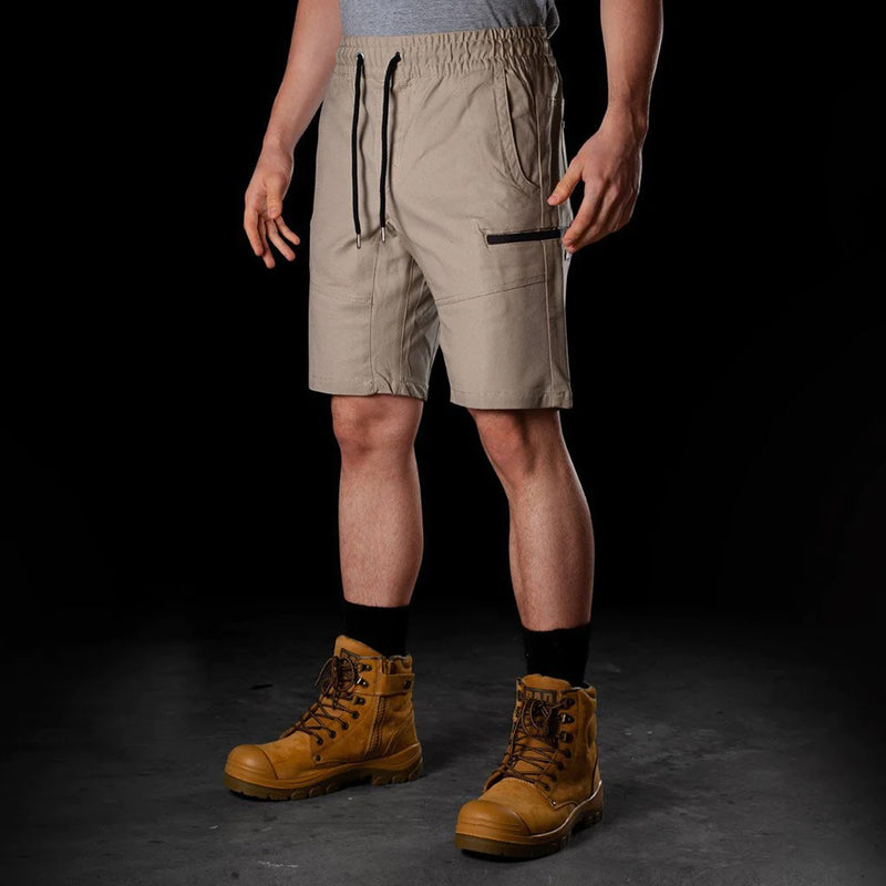 Load image into Gallery viewer, BAD Saviour Elastic Waist Work Shorts, featuring reinforced pockets and a 4.5-inch inseam, worn with brown safety boots. Designed for comfort with adjustable drawstring and Freemove™ fabric, ideal for active work environments.