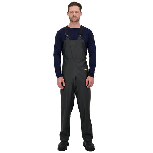 Line 7 Station Bib Trouser V2, Green, features a man in durable, abrasion-resistant overalls with adjustable braces, designed for reliable waterproof protection in wet conditions, ideal for farm or yard work.