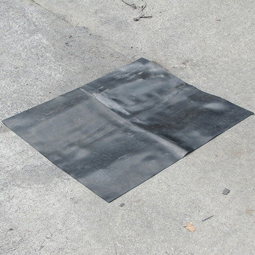 SpillTech Nitrile Drain Mat 600 x 800 placed on a concrete surface, designed to cover stormwater drains, effectively preventing chemical and hydrocarbon spills from entering. Ideal for workplace safety applications.