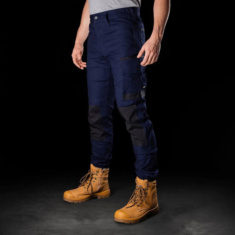 Load image into Gallery viewer, BAD Attitude Slim Fit Cuffed Work Pants featuring brown boots, highlighted for their reinforced features and practical utility pockets, ideal for safety and work environments.