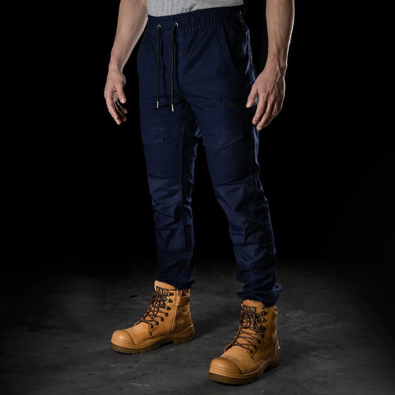 Load image into Gallery viewer, BAD Saviour Cuffed Elastic Waist Work Pants showcased with brown boots, featuring a slim fit, reinforced pockets, and utility pockets. Ideal for safety-conscious work environments, highlighting comfort and practicality.