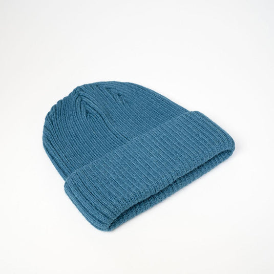 UFlex Fishermans Beanie, a ribbed knit hat with a cuffed hem, ideal for safety-conscious environments. Made from a blend of viscose, nylon, and polyester, ensuring durability and comfort.