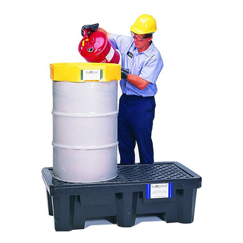 A man in safety gear places a red cylinder on the Ultra Spill Pallet, 2 Drum, designed for containing two drums and made from durable polyethylene for chemical resistance.