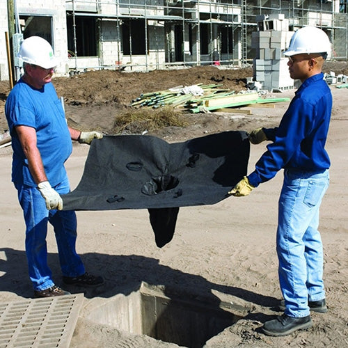 Men in hard hats demonstrate the Ultra Drain Guard 1220 x 910mm, holding its black polypropylene geotextile material designed for effective sediment and oil filtration in stormwater systems.
