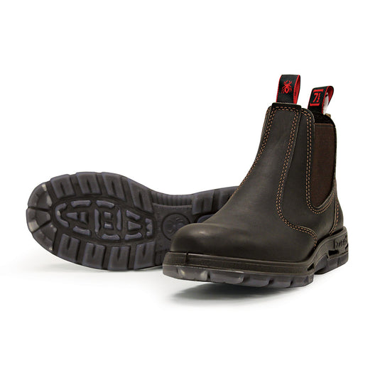 Redback Bobcat (Non Safety) black boots feature a slip-on design with elastic sides, crafted from premium full grain New Zealand leather, showcasing durability and comfort with acid and oil-resistant soles.