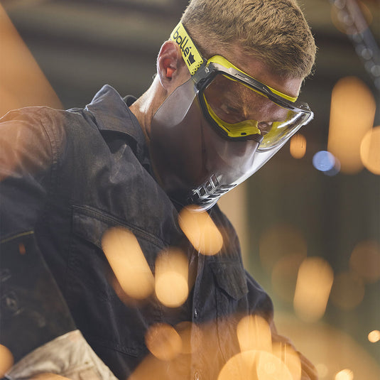 Man wearing Bolle Universal Goggle with Mouth Guard Vented: Clear, featuring ergonomic design and Wave technology for optimal fit and protection, as part of New Zealand's top safety gear collection.