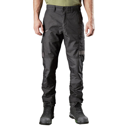 Model wearing FXD WP-5 Stretch Work Pants with multiple utility pockets and black lace-up work boots, showcasing durable, quick-dry fabric with reinforced panels, ideal for active workplace safety.