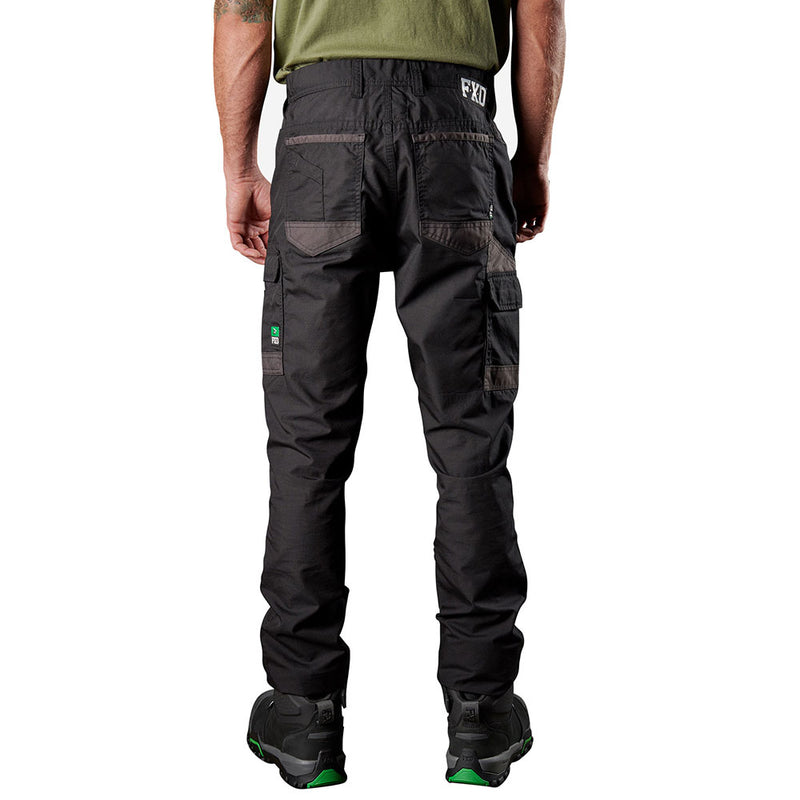 Load image into Gallery viewer, Model wearing FXD WP-5 Stretch Work Pants, showcasing multi-pocket design and reinforced stitching, paired with black boots. Ideal for durability and comfort, reflecting Active Safety's commitment to quality workwear.