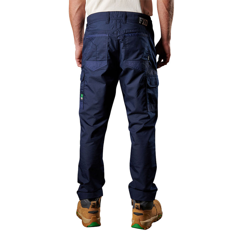 Load image into Gallery viewer, FXD WP-5 Stretch Work Pants showcased from the rear, highlighting multiple utility pockets, flap cargo pockets, and a logo patch, paired with tan work boots, embodying durability and flexibility for active safety environments.